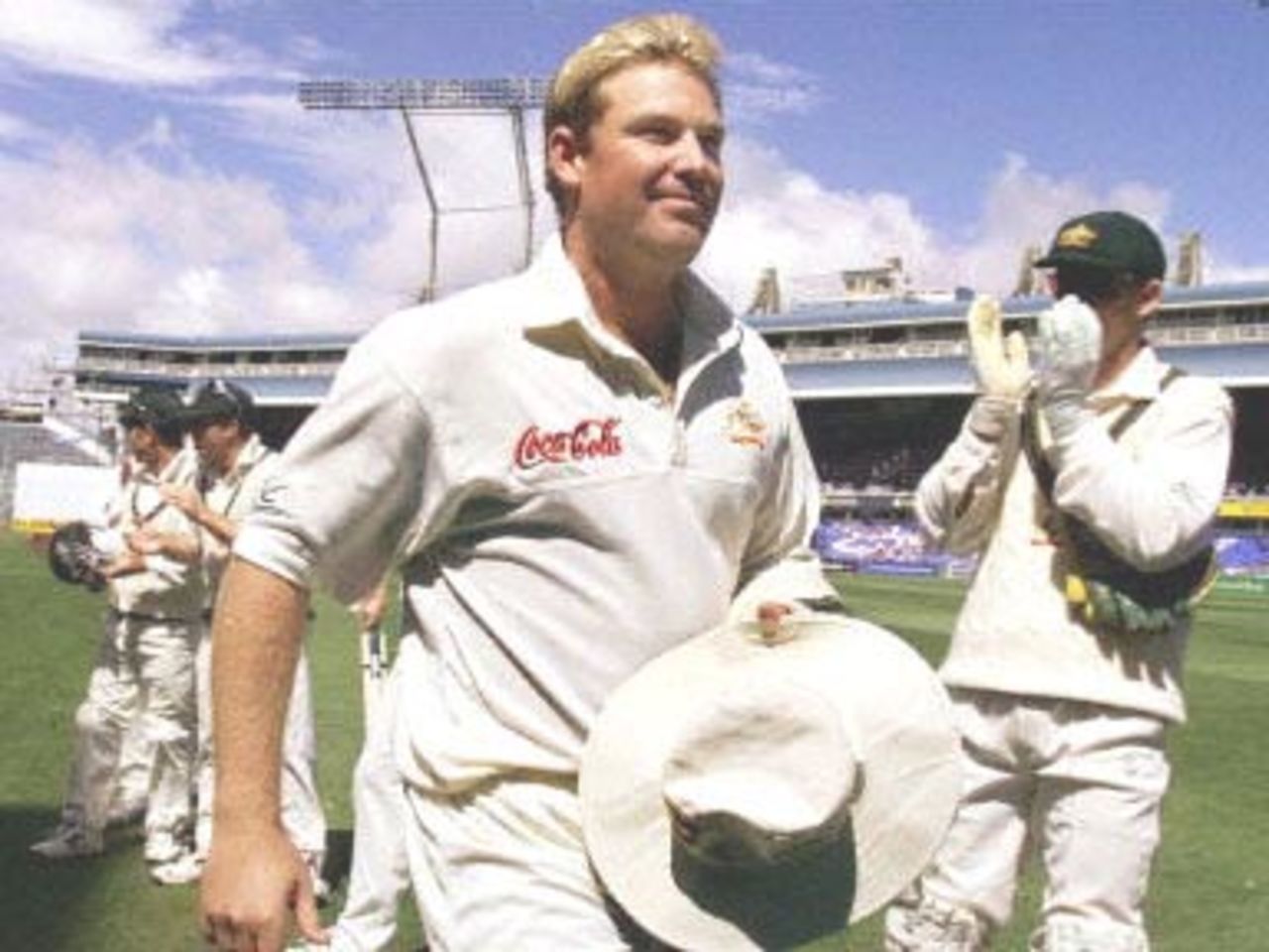 Australian Shane Warne (C) leaves the field after breaking the Australian Test wicket-taking record held by former paceman Dennis Lillee, on the final day of the first Test at Eden Park in Auckland 15 March 2000. Warne got his 356th career dismissal as Australia defeated New Zealand by 62 runs.