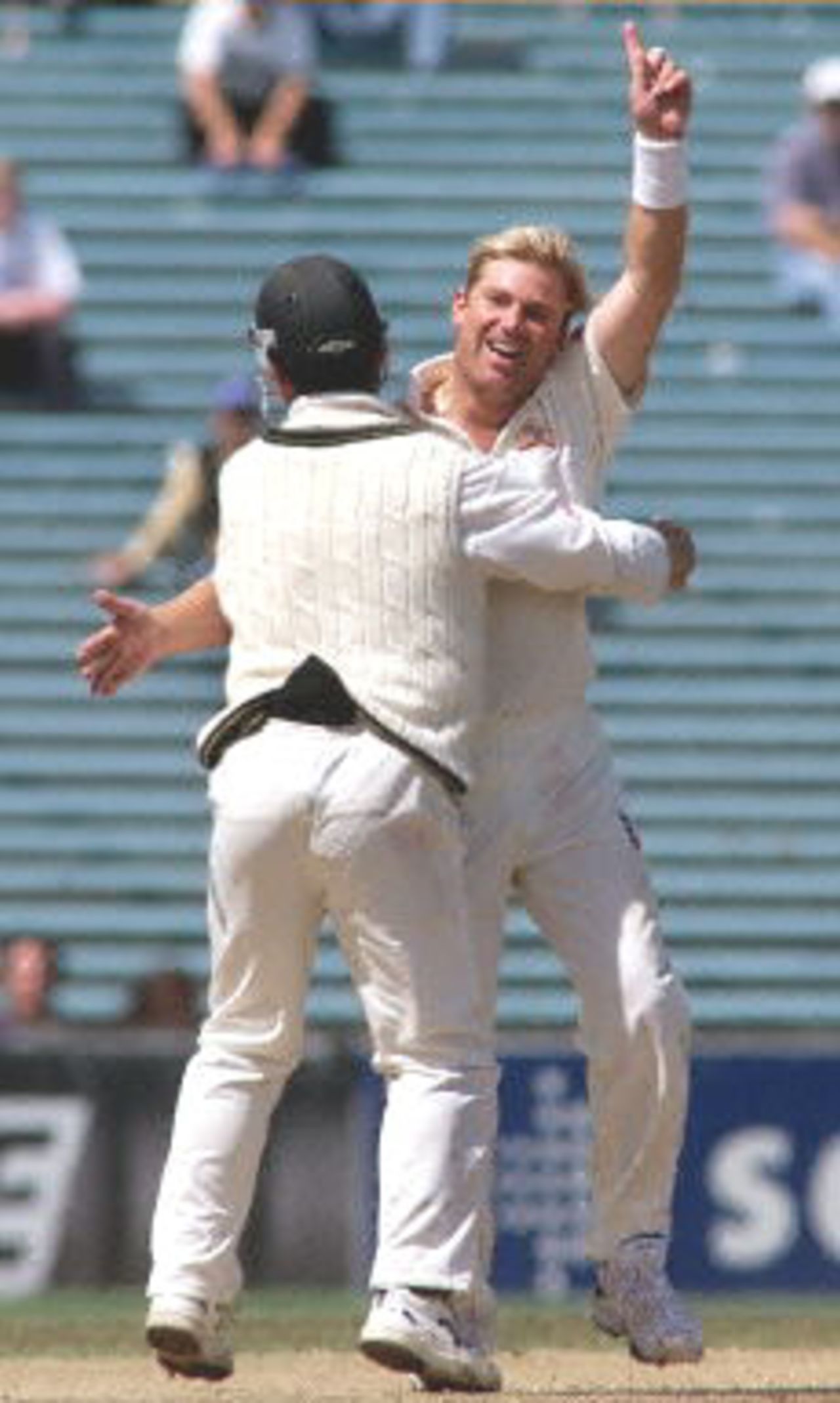 Australian spinner Shane Warne (R) celebrates with Justin Langer (L) after taking the wicket of New Zealand batsman Paul Wiseman, his 356th career dismissal, to break the former Australian Test wicket-taking record of 355 held by former paceman Dennis Lille, on the last day of the first Test match between Australia and New Zealand at Eden Park in Auckland 15 March 2000. Australia defeated New Zealand by 62 runs and in doing so also equalled the Australian record for consecutive Test victories at eight.