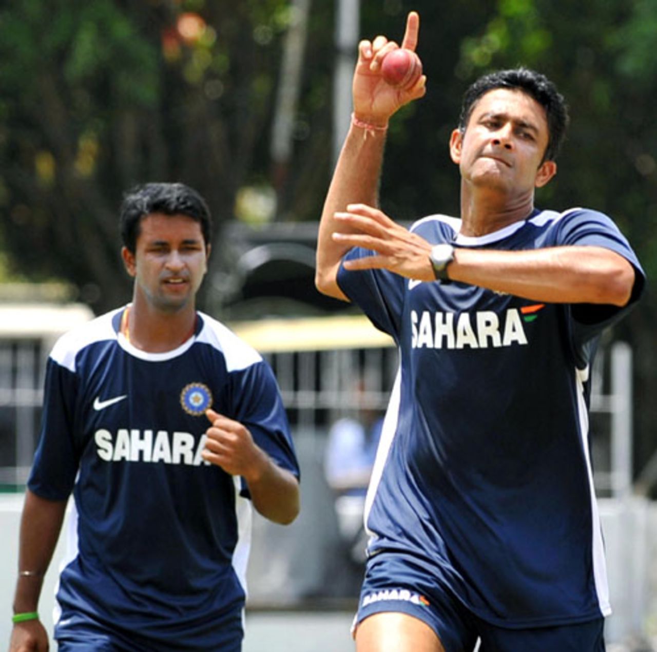 Anil Kumble readies to bowl during practice as Pragyan Ojha waits his turn, Colombo, July 21, 2008