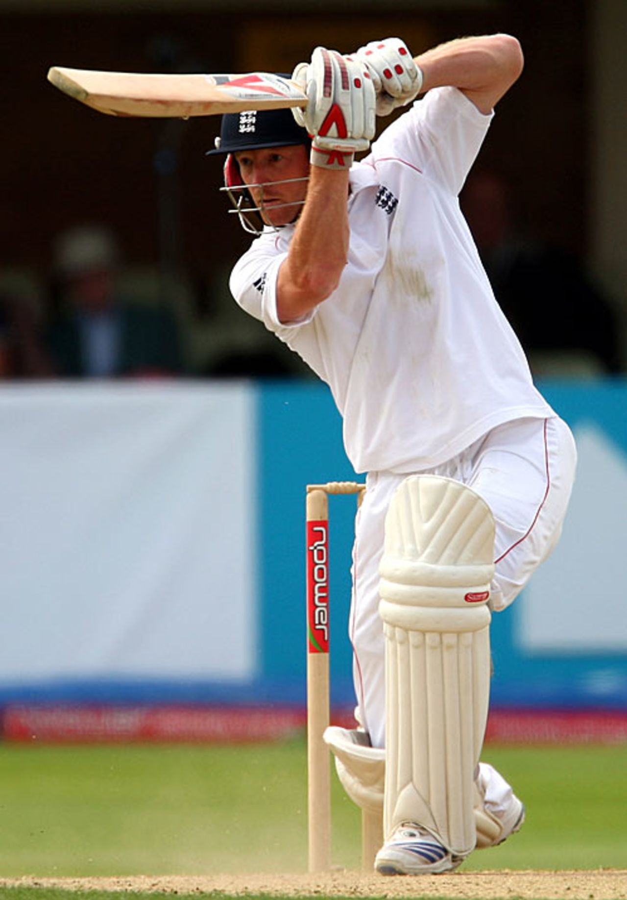 A cricket player, Paul Collingwood, elegantly maneuvering through extra cover, showcasing fluid motion.