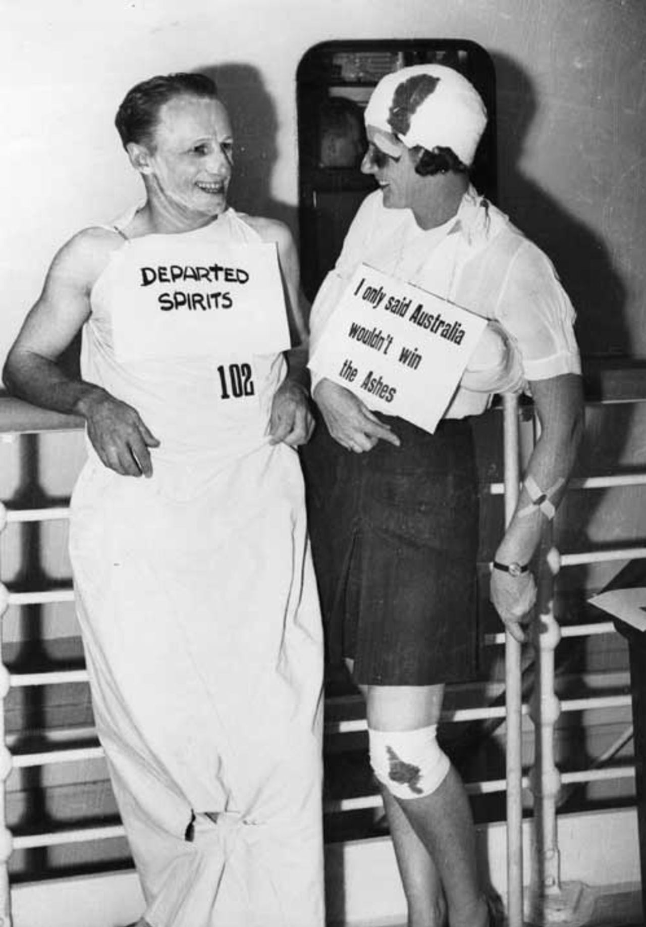 Don Bradman and a lady friend enjoy a chat at a fancy dress party
