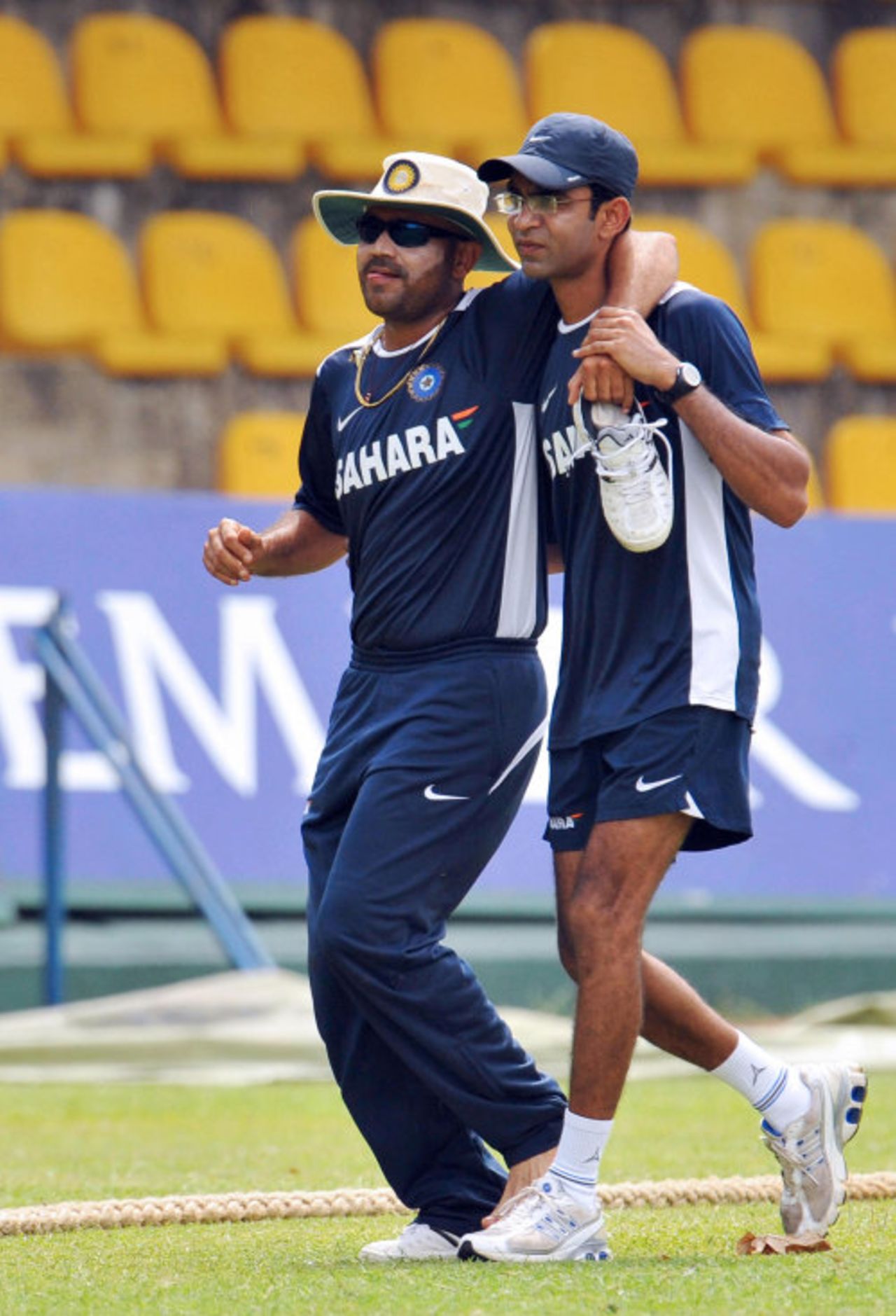 Virender Sehwag is led away by physio Nitin Patel after twisting his left foot in practice, Dambulla, August 17, 2008