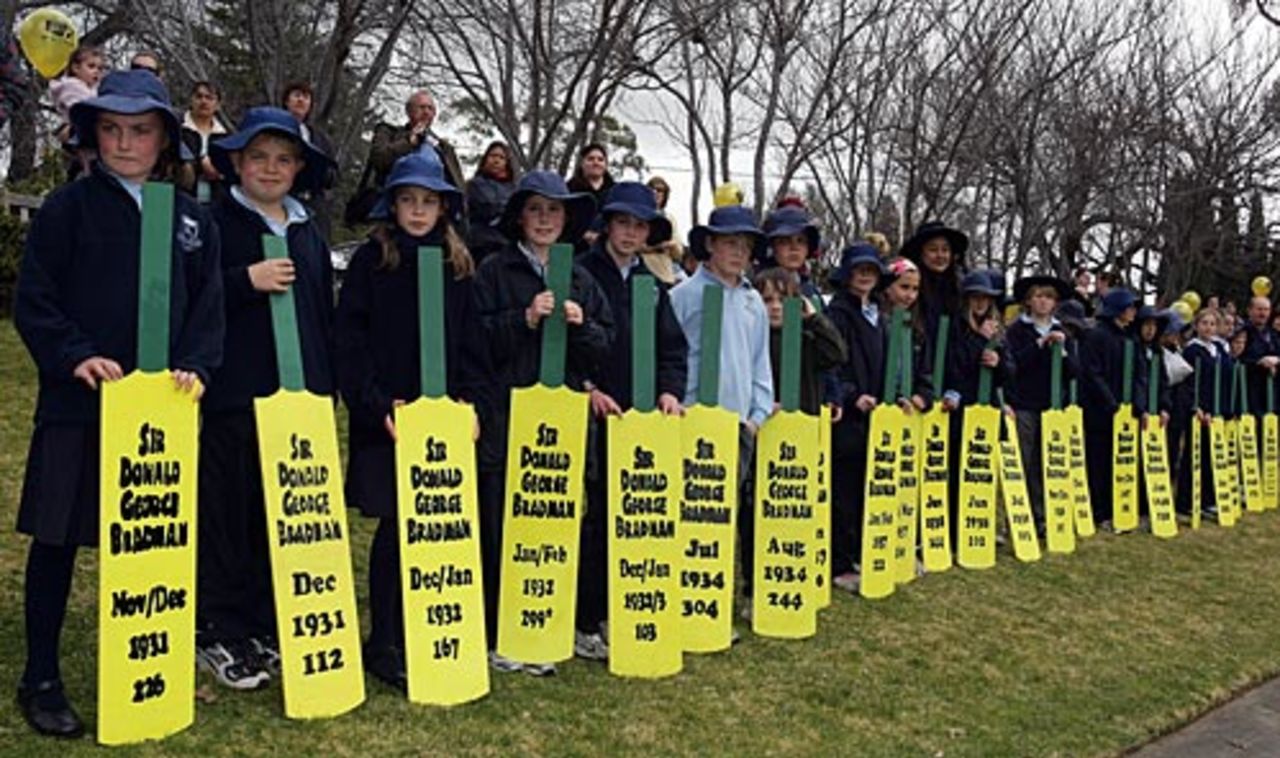 School children display the scores of Donald Bradman at The Bradman Oval to mark his centenary, Bowral, August 27, 2008