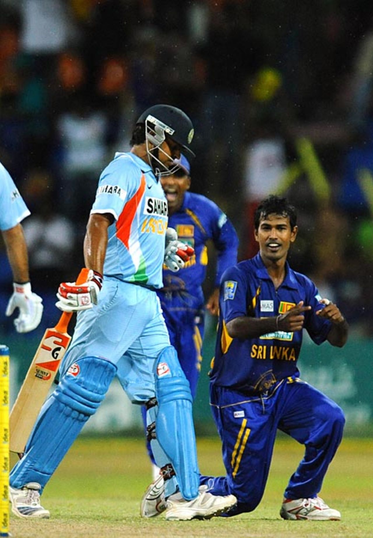 Nuwan Kulasekara shows Suresh Raina the way to the pavilion, Sri Lanka v India, 5th ODI, Colombo, August 29, 2008 
