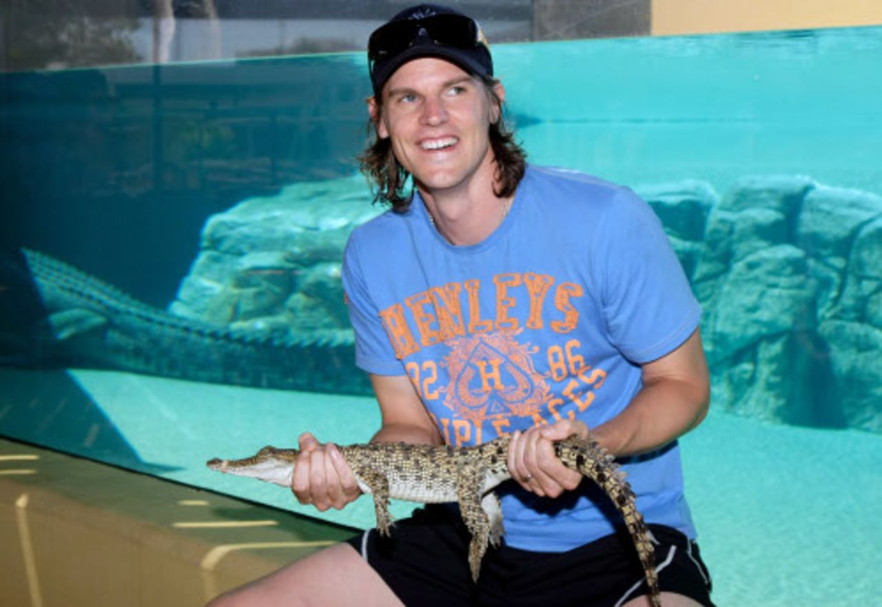 Nathan Bracken holds a crocodile at the Crocosaurus Cove theme park, Darwin, August 31, 2009