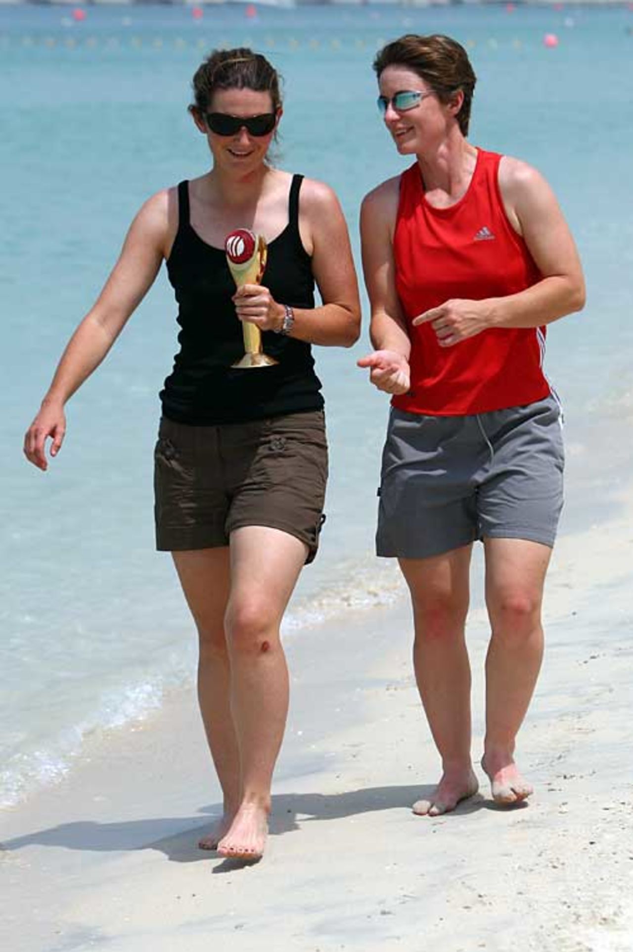 Charlotte Edwards and Claire Taylor walk along the beach in Dubai, September 11, 2008