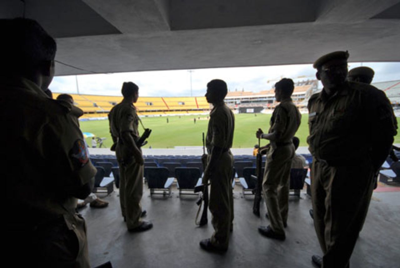Police officers stand guard during the game between New Zealand A and Australia A in Hyderabad. Security has been beefed up since five explosions struck a park and crowded shopping areas in New Delhi on Saturday, killing 21 people and wounding about 100 others, September 15, 2008