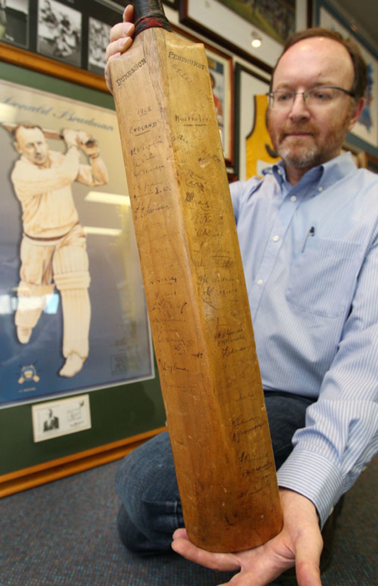 Auctioneer Charles Leski holds up the first cricket bat used by Sir Donald Bradman in his Test career and which will be auctioned off in Melbourne. The bat did not see much action in that first Test, but is expected to fetch up to US$100,000 when auctioned. Bradman was dropped after an inauspicious debut in which he scored 18 and one in Australia's 675-run thrashing by England in the first Test in Brisbane in 1928-29. The bat was signed by the entire 1928-29 Australian team as well as the conquering English who won the series 4-1. Forty-seven signatures in total are on the bat. Melbourne, September 24, 2008