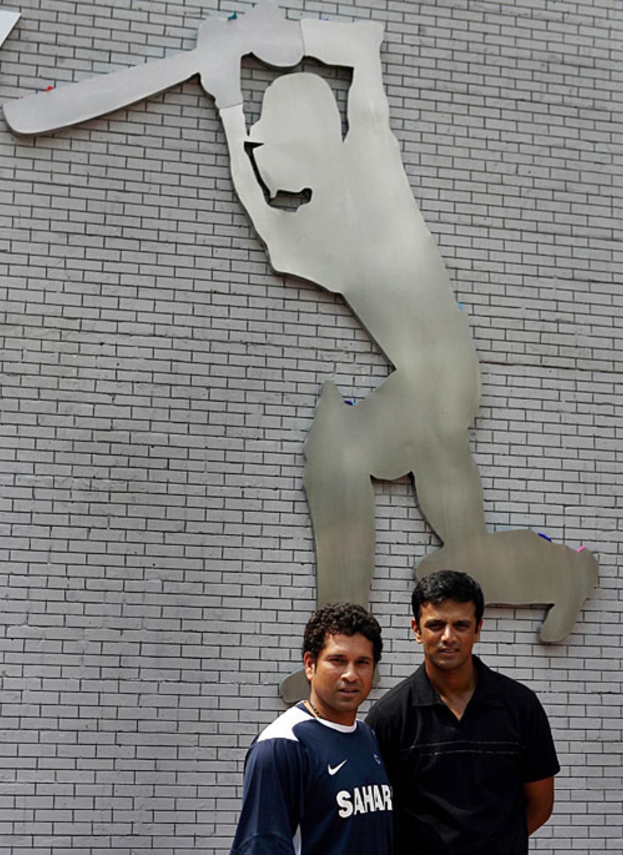 Rahul Dravid and Sachin Tendulkar pose in front of 'the wall' unveiled to honour Dravid for reaching 10,000 runs in both forms of the game, Bangalore, October 6, 2008