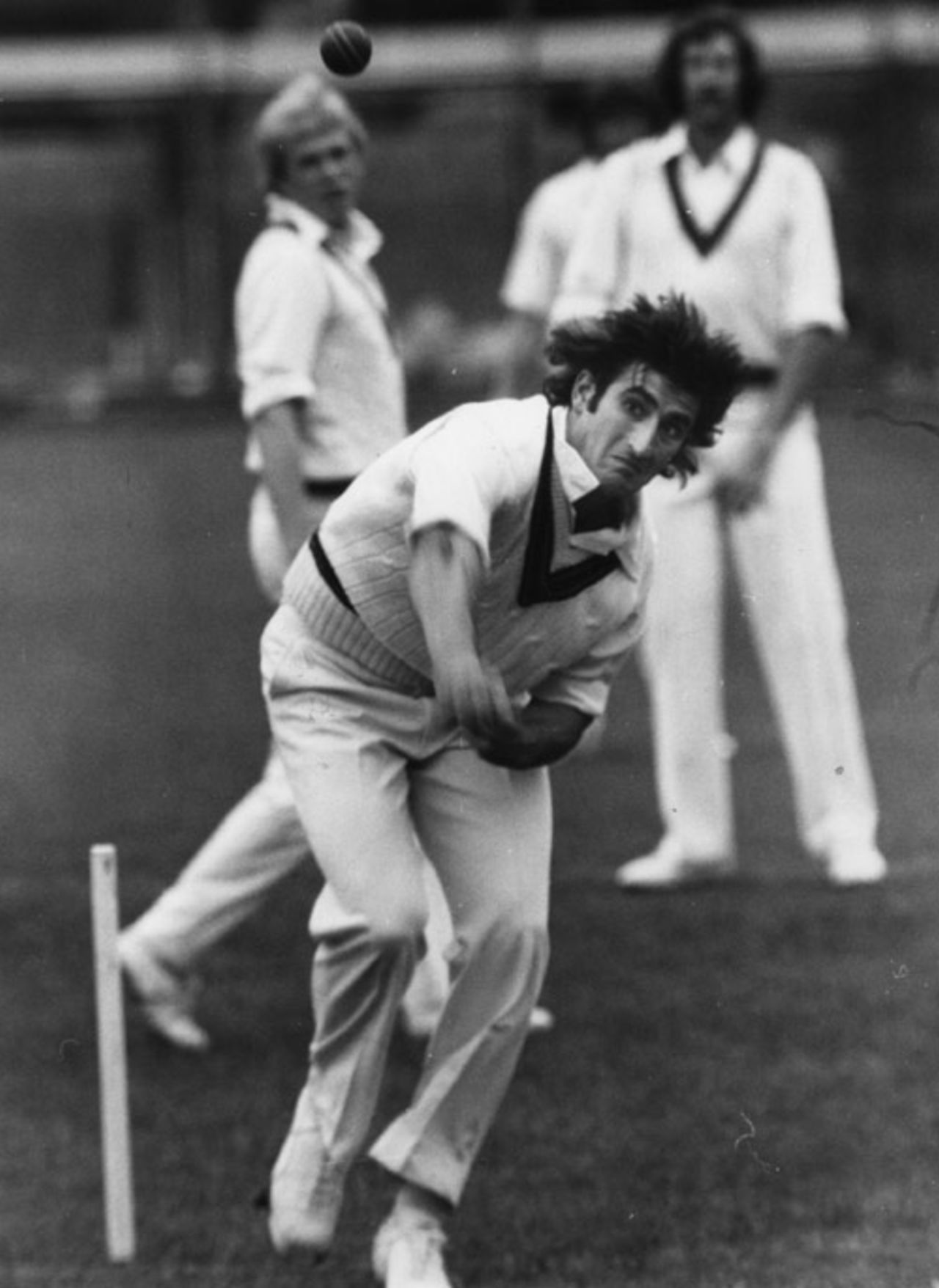 Len Pascoe sends down a delivery, 1975