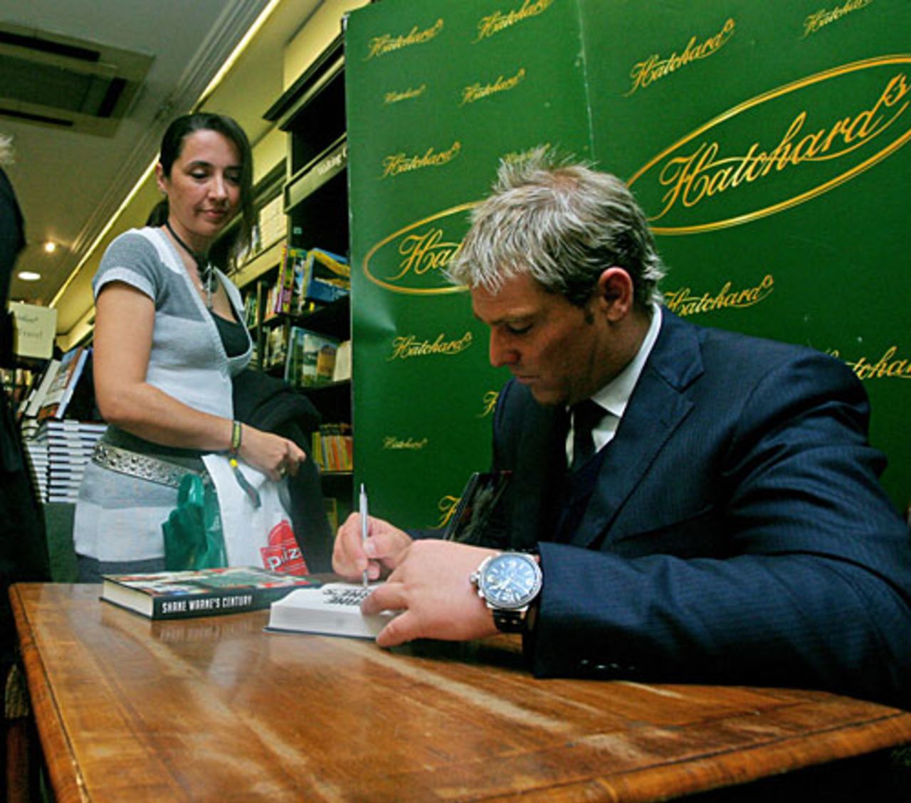 Shane Warne signs his book for a fan at a promotional event, London, October 7, 2008