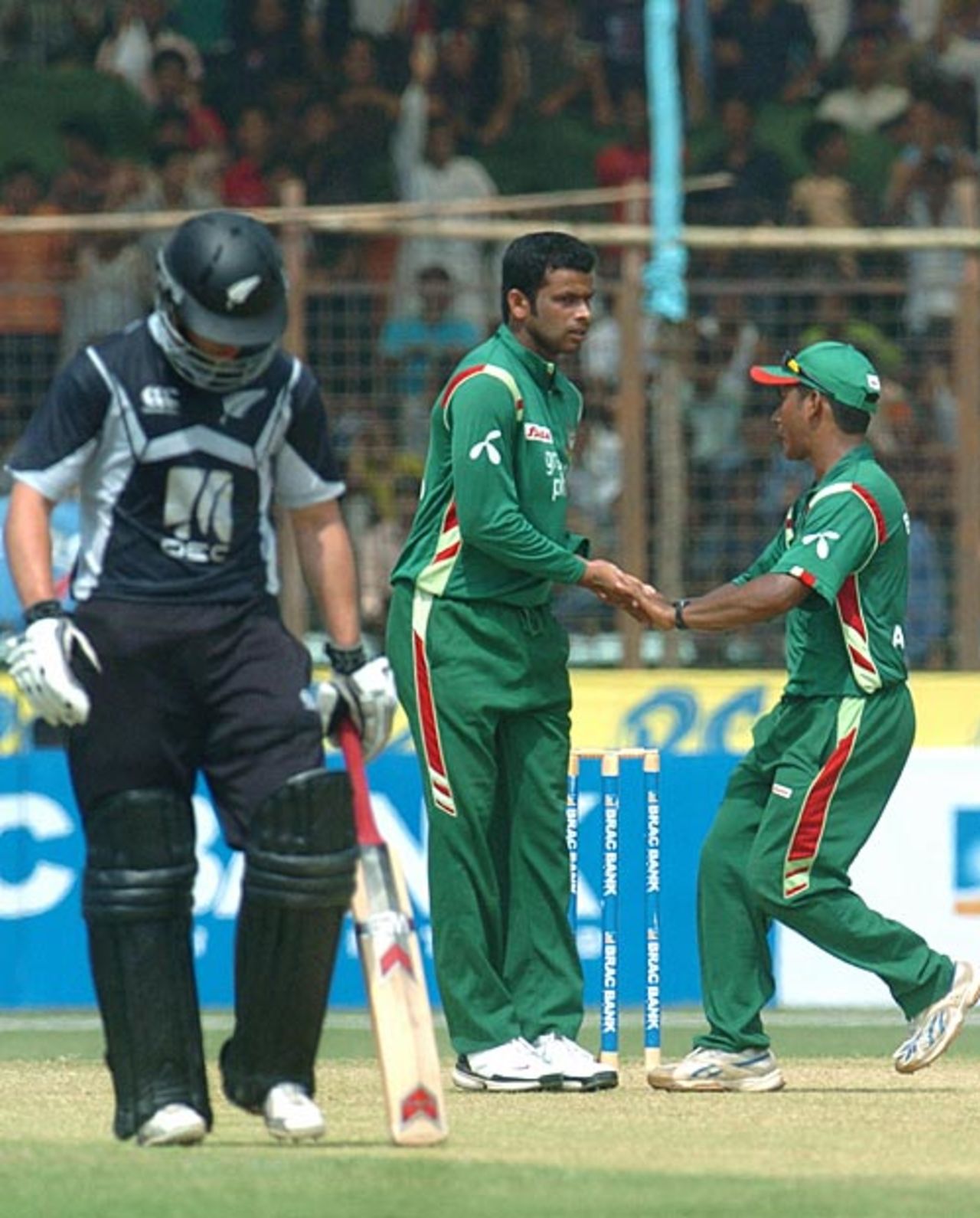 Abdur Razzak is congratulated by Mohammad Ashraful after removing Daniel Flynn, Bangladesh v New Zealand, 3rd ODI, Chittagong, October 14, 2008