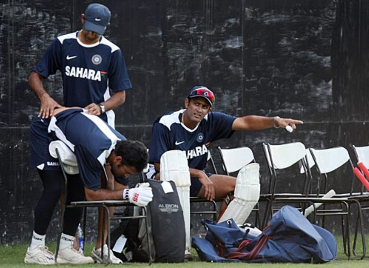 Mahendra Singh Dhoni is attended to by the physio as Anil Kumble draws the attention of the ground staff, Mohali, October 15, 2008