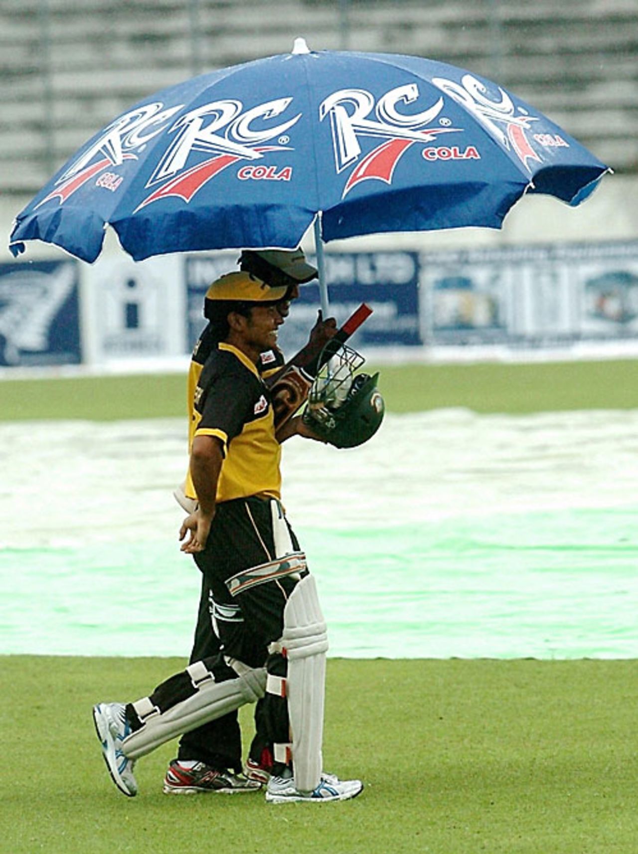 Under my umbrella - A couple of Bangladesh players are forced to take shelter, Bangladesh v New Zealand, 2nd Test, Mirpur, 1st day, October 25, 2008