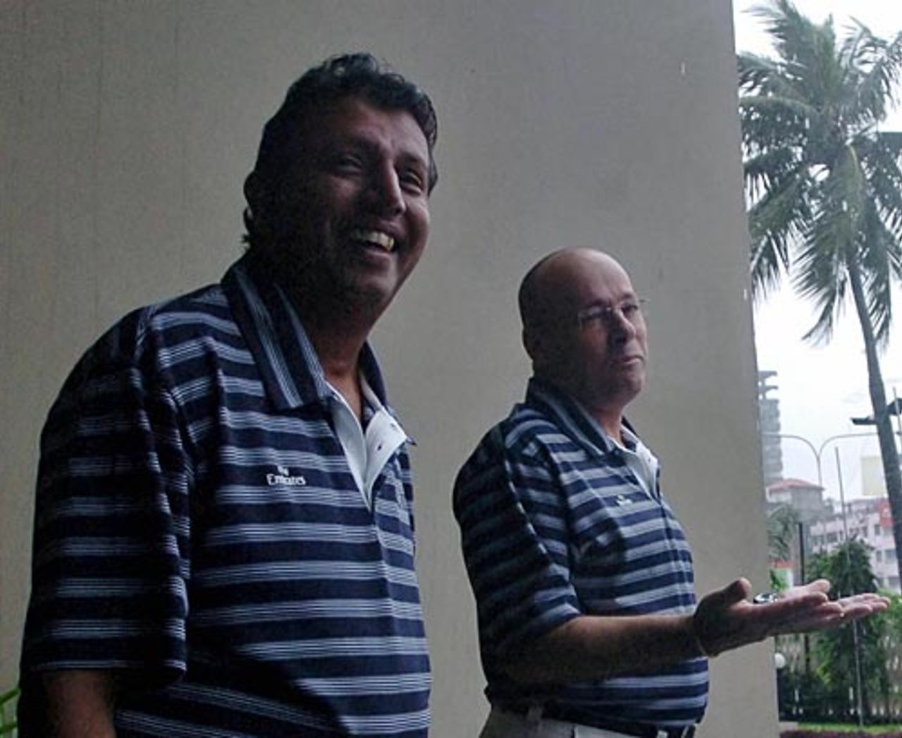 Asoka de Silva and Daryl Harper share a joke despite the relentless rain, Dhaka, October 26, 2008