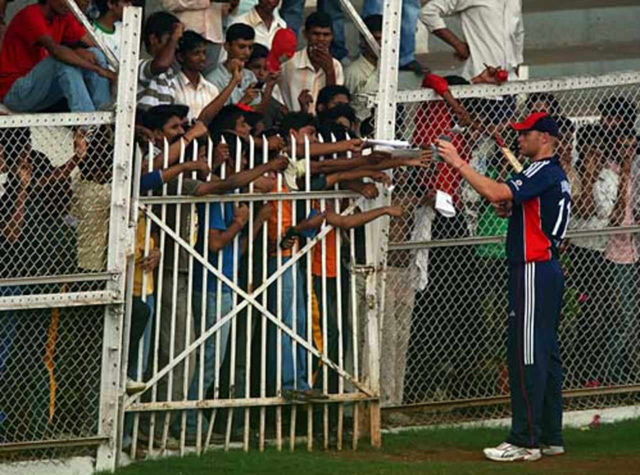 Popular man: Andrew Flintoff signs autographs while England field, Mumbai XI v England XI, Mumbai, November 9, 2008