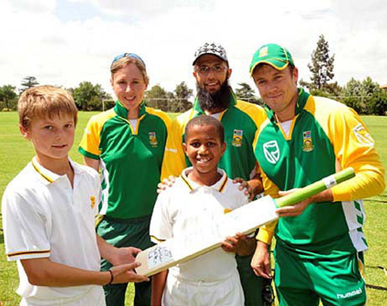 Cri-zelda Brits, Hashim Amla and AB de Villers hand an autographed bat to school children as part of ICC's World Diversity Day, Johannesburg