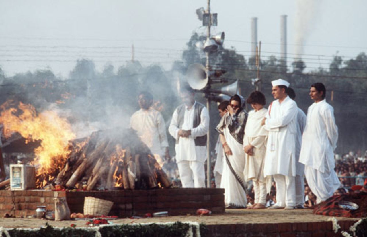 Indira Gandhi's son, Rajiv, his wife Sonia, and their daughter Priyanka, watch the pyre of the Indira Gandhi during the cremation ceremony, November 3, 1984