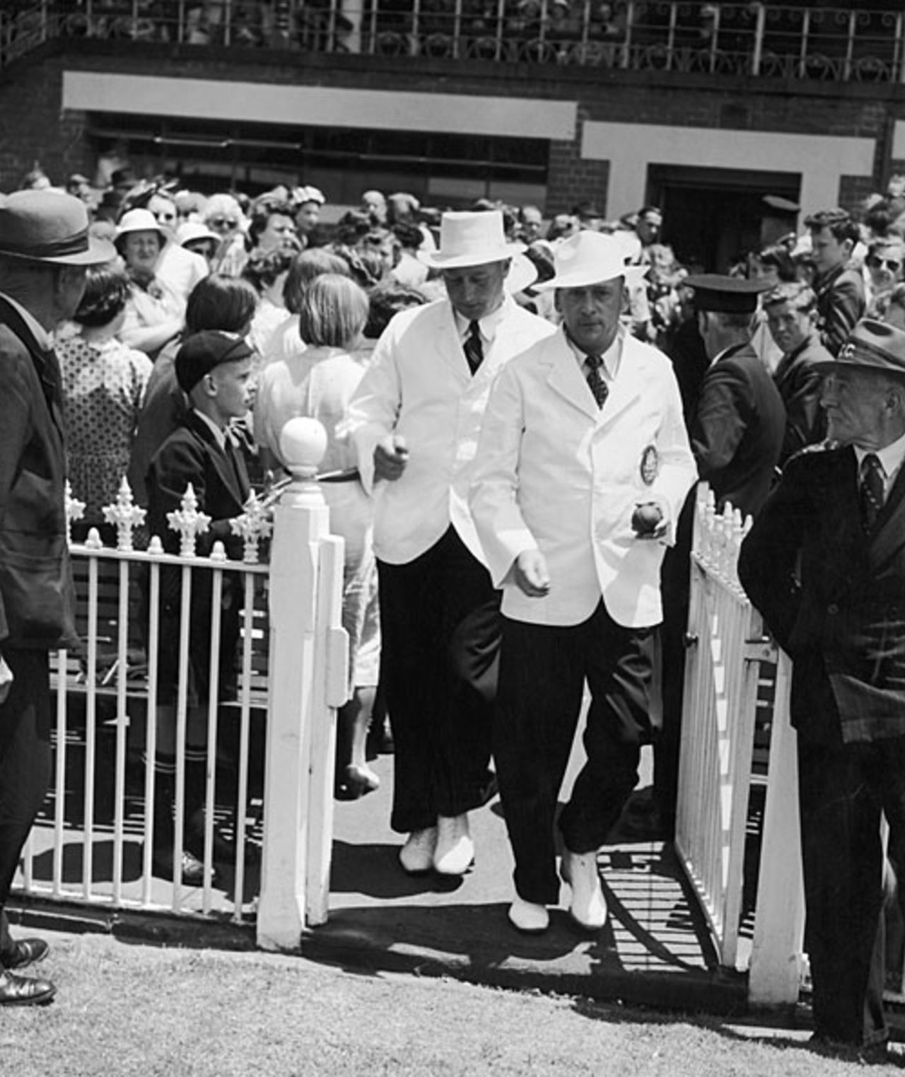 Umpires Ronald Wright and George Cooper walk on to the field on Boxing Day, Australia v England, MCG, 3rd day, December 26, 1950