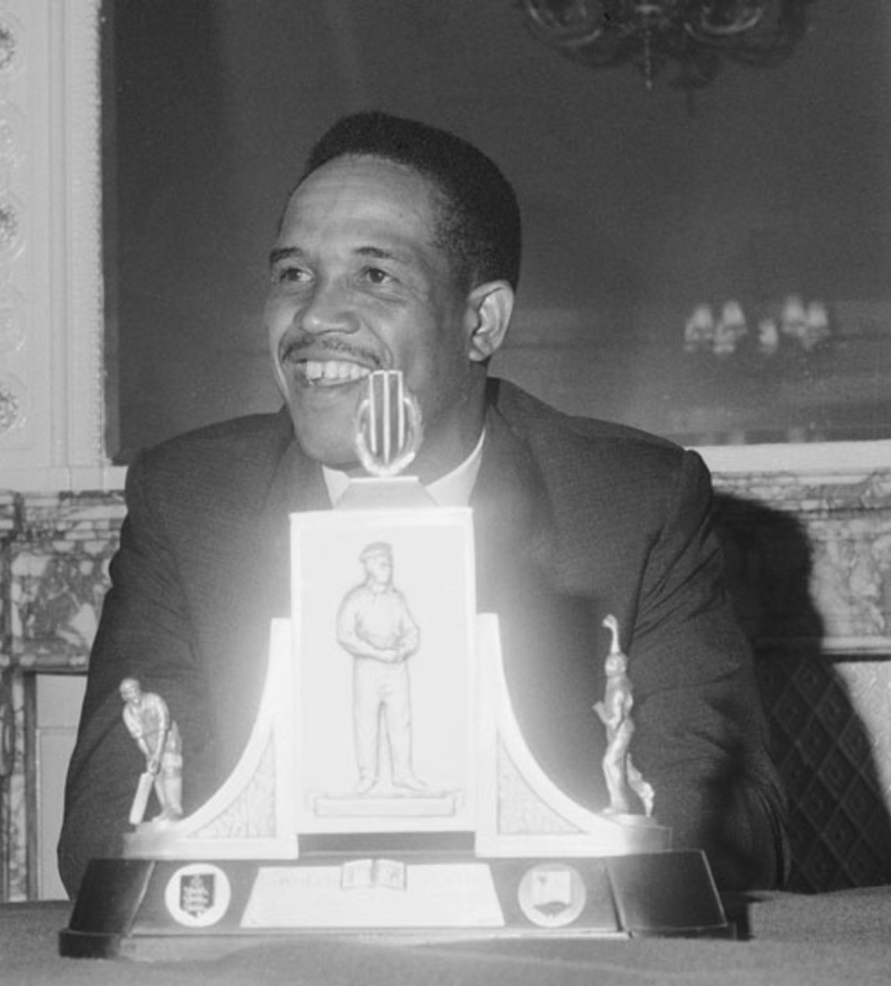 Garry Sobers sits behind the Wisden Trophy during a press reception, London, 1966