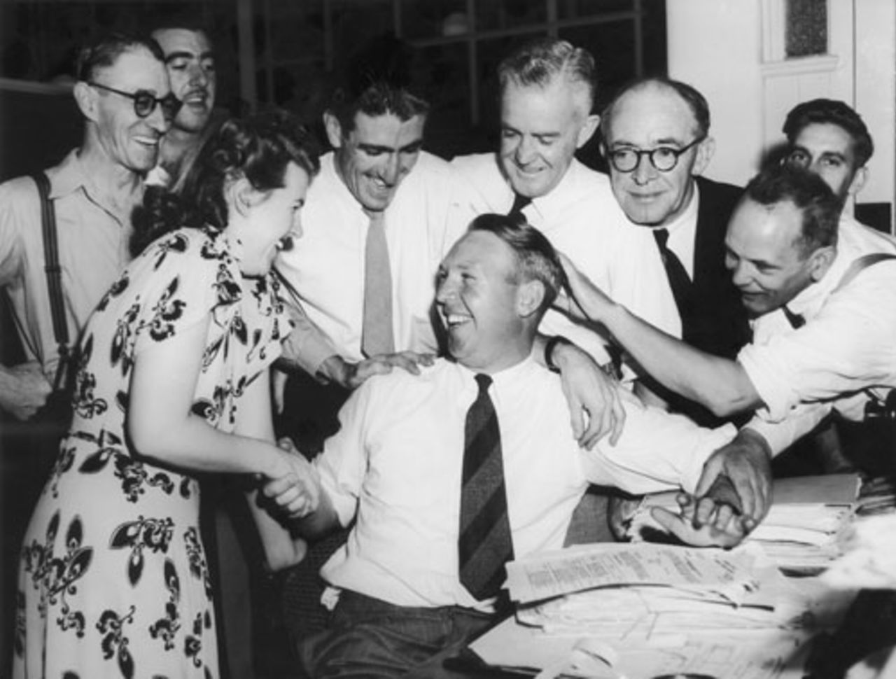 Doug Ring is congratulated by his colleagues at the Melbourne Department of Commerce for being picked in the Australian squad for the tour to England, February 25, 1948