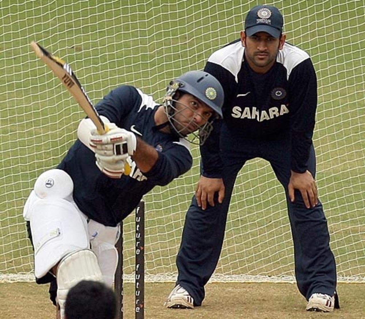 Yuvraj Singh cuts loose at the nets under the watchful eyes of Mahendra Singh Dhoni, Chennai, December 9, 2008