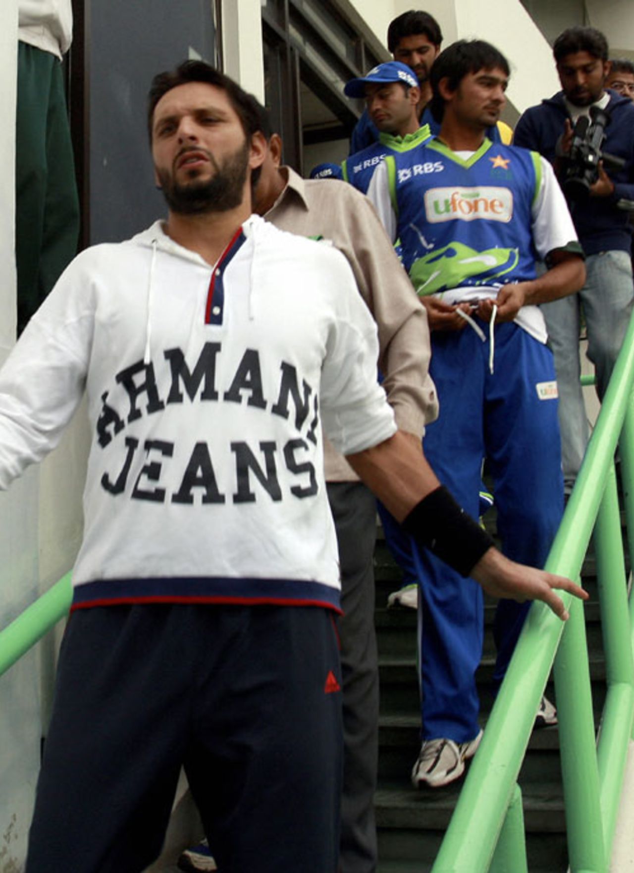 Pakistani cricketers walk down a stairway as they leave the National Stadium,  Karachi, December 18, 2008