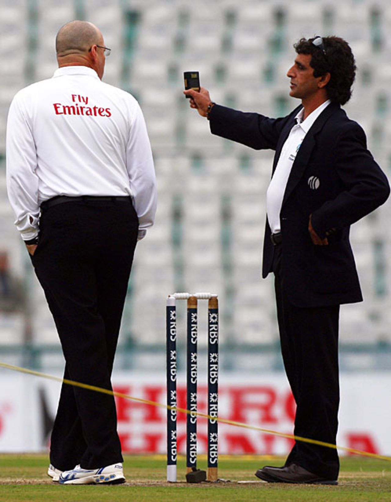 Umpire Asad Rauf checks the light conditions as his colleague Daryl Harper looks on, India v England, 2nd Test, Mohali, 1st day, December 19, 2008