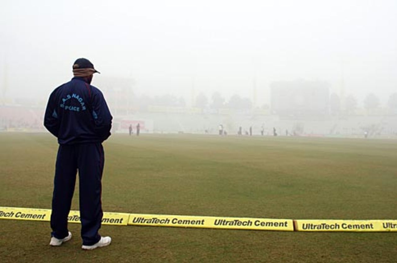 A security officer stands guard amidst the fog cover, India v England, 2nd Test, Mohali, 4th day, December 22, 2008