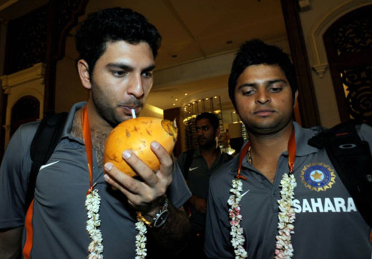 Yuvraj Singh enjoys a coconut drink as Suresh Raina looks on, Colombo, January 26, 2009