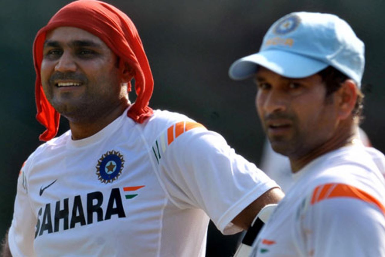 Virender Sehwag has something to smile about while Sachin Tendulkar looks on during a training session, Colombo, January 30, 2009