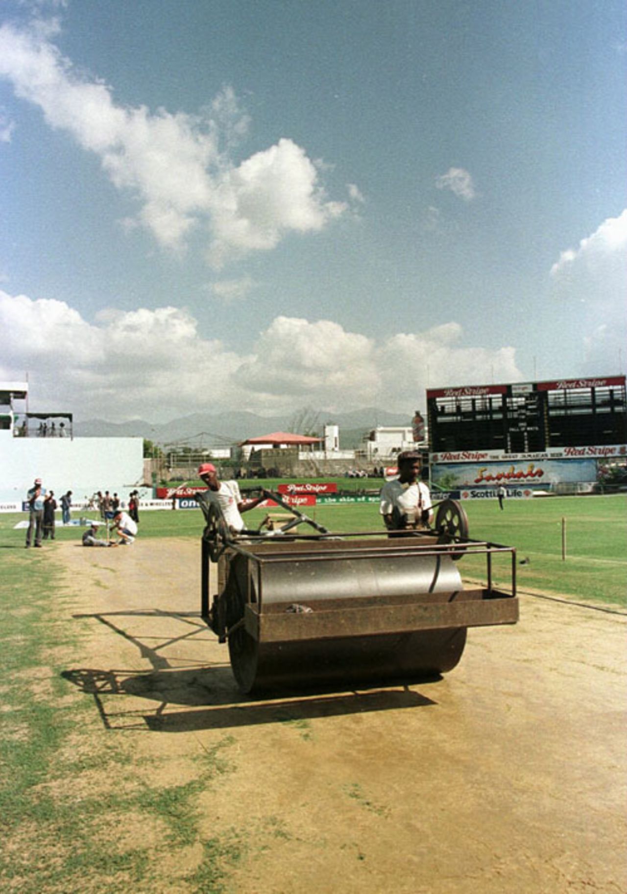 The groundstaff put the finishing touches to the pitch preparation at Sabina Park pitch with the match officials shortly before the abandonment of the Test, West Indies v England, 1st Test, Jamaica, January 29, 1998