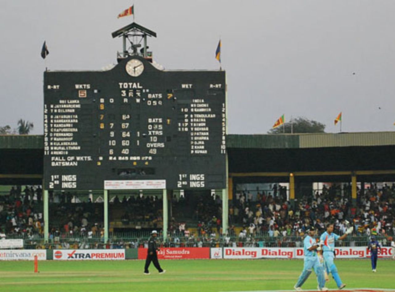 Mahendra Singh Dhoni and Yusuf Pathan walk back to the pavilion with the gigantic scoreboard in the background, Sri Lanka v India, 3rd ODI, Colombo, February 3, 2009