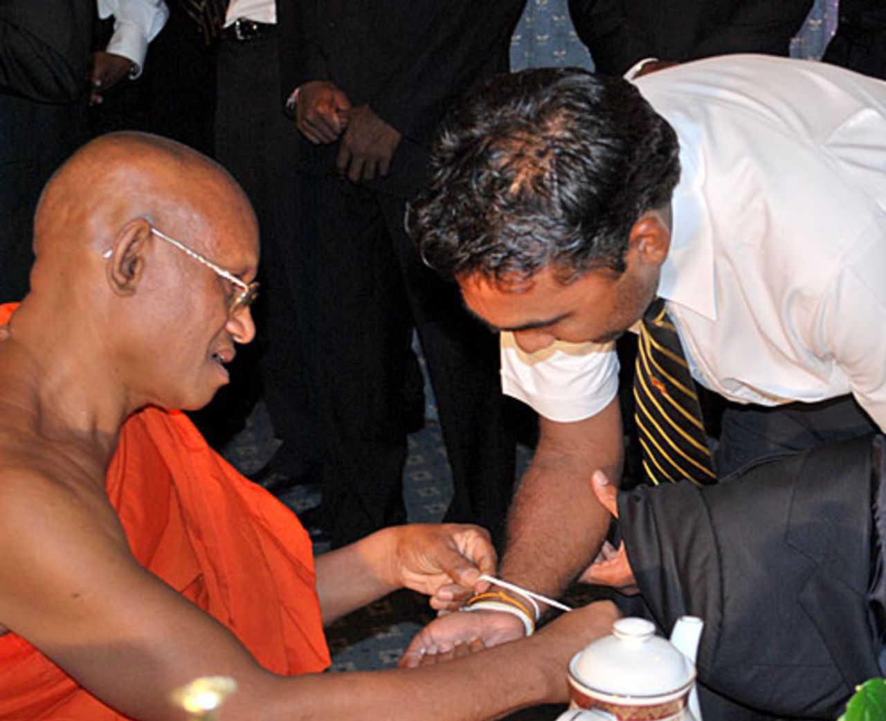 Mahela Jayawardene receives good wishes from a Buddhist monk, Colombo, February 14, 2009
