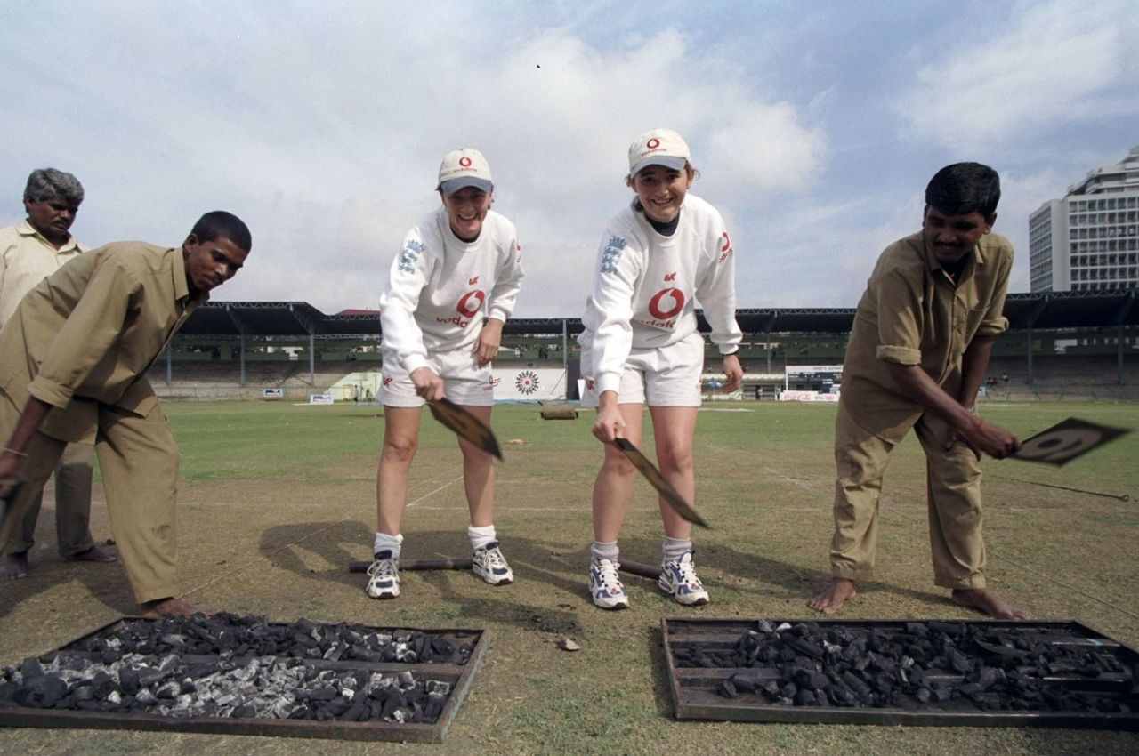 Clare Taylor (left) and Charlotte Edwards try their hand at drying the pitch, England v South Africa, Hyderabad, World Cup, 10 December 1997