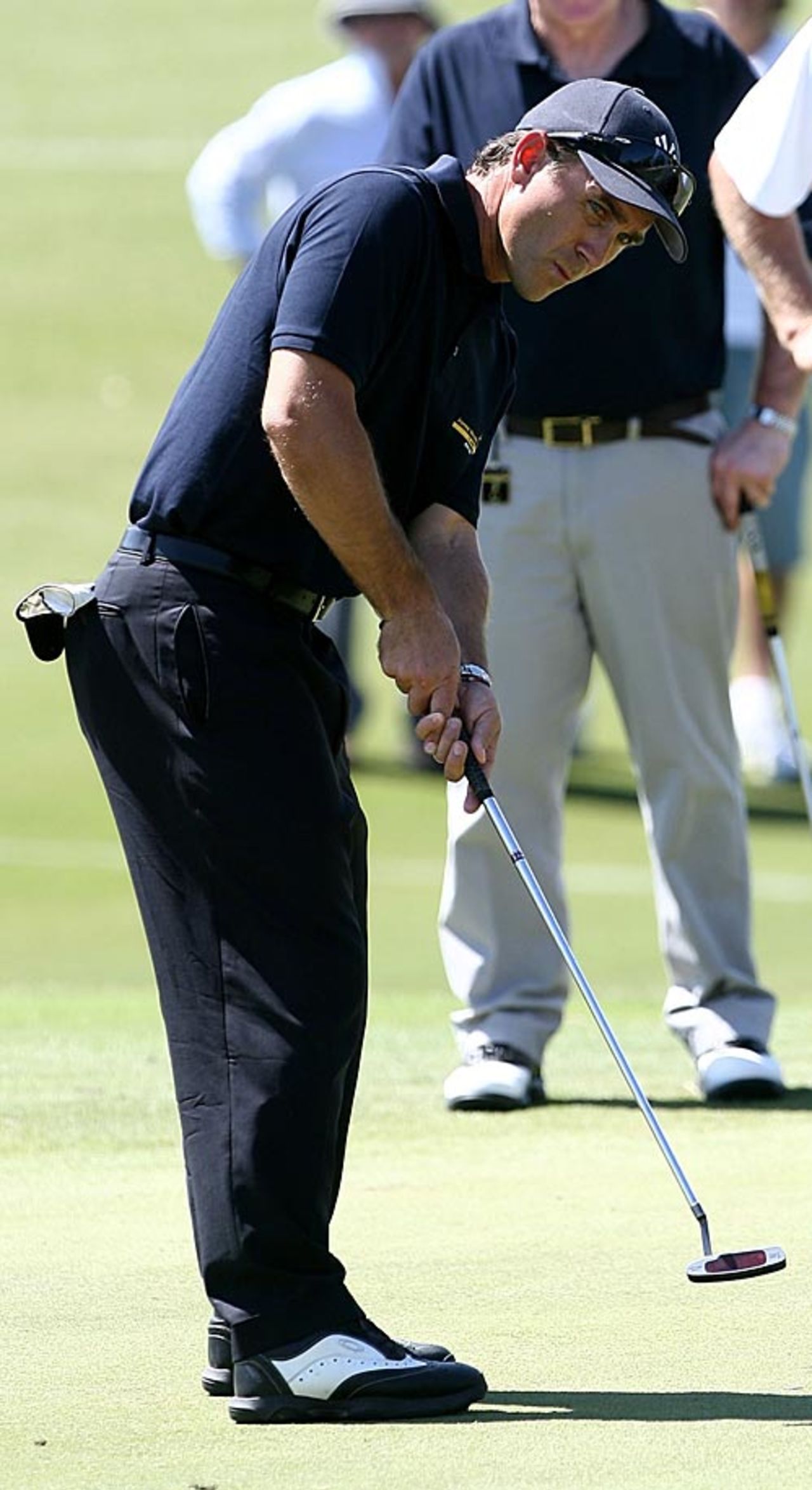 Justin Langer makes a putt at a charity golf event, Perth, February 17, 2009