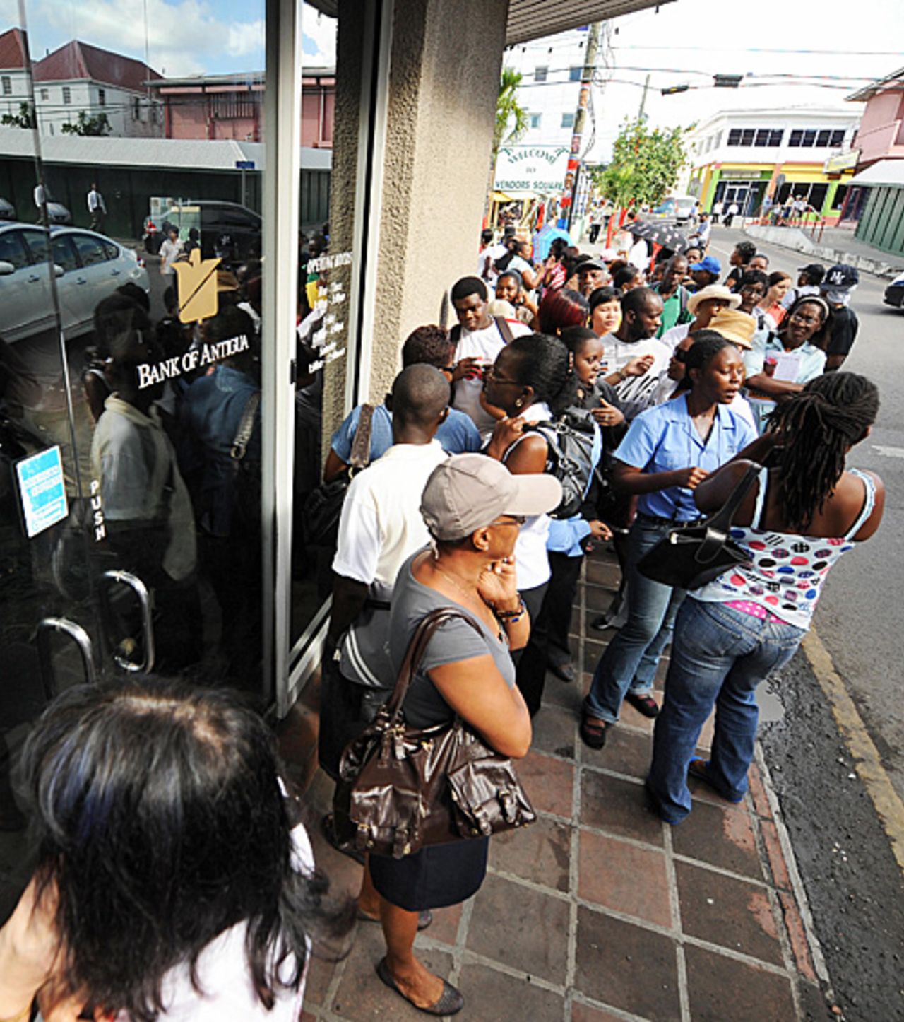 People queue outside a Bank of Antigua, owned by the Stanford Group, after it was revealed Allen Stanford was charged with fraud, St John's, Antigua, February 18, 2009