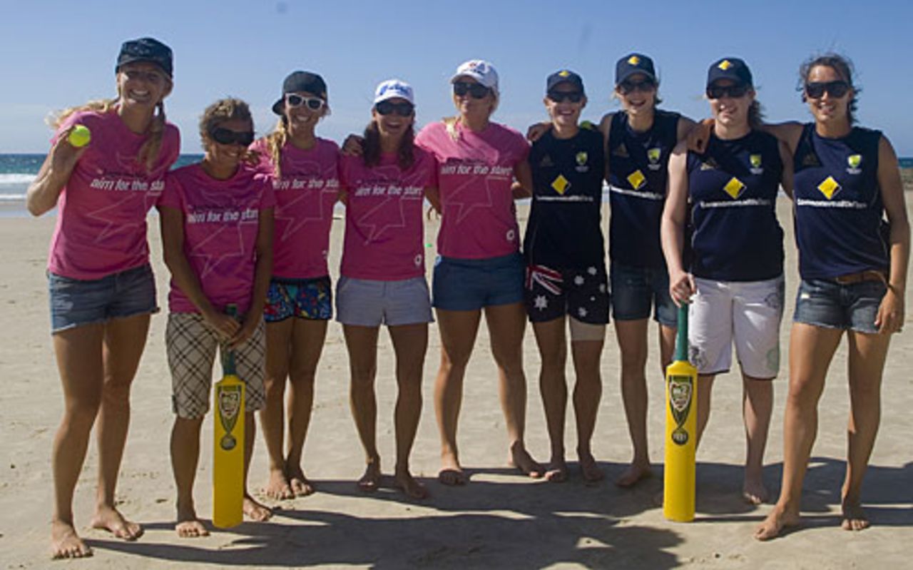Australian surfers and cricketers pose for photos at a beach cricket game, Gold Coast, March 1, 2009