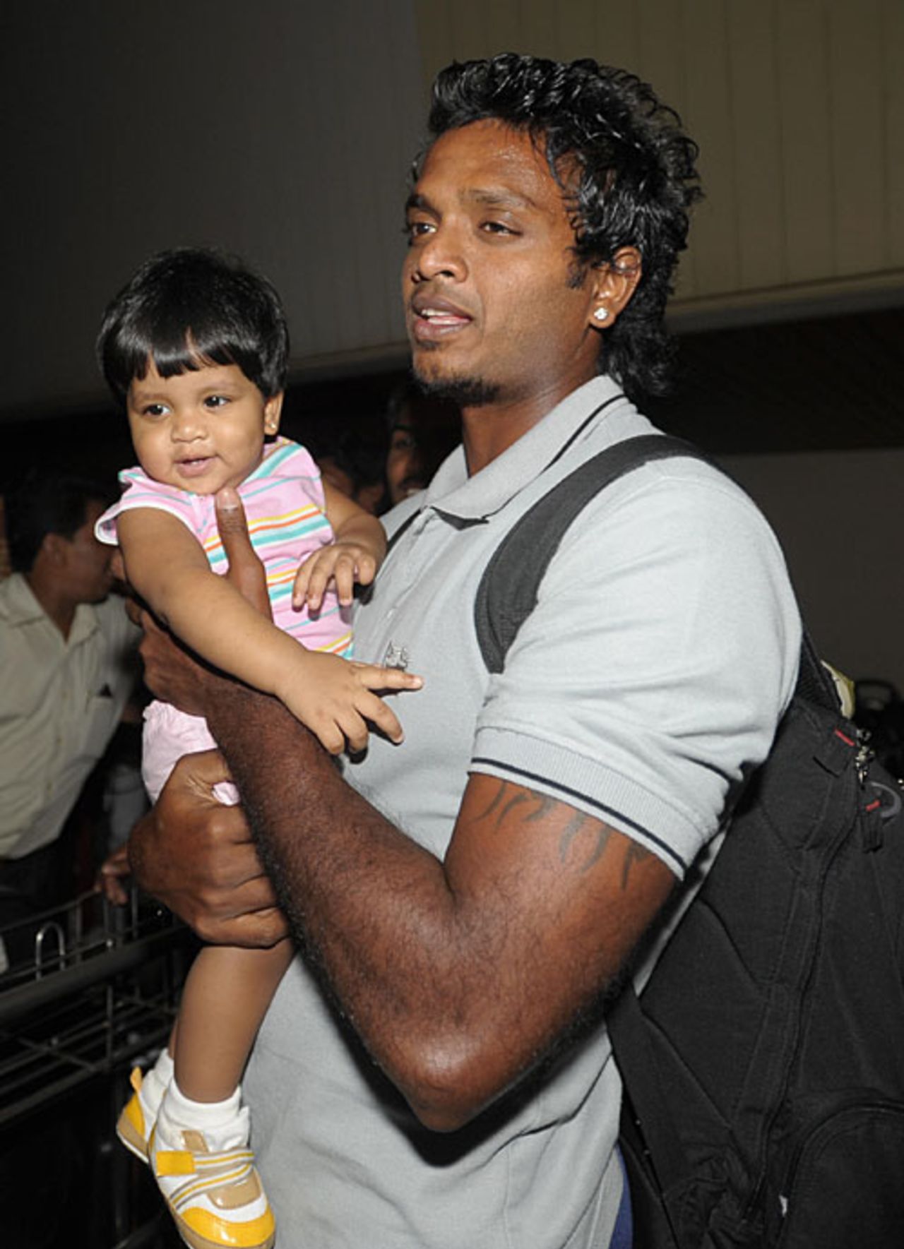 Dilhara Fernando holds his daughter after returning from Pakistan, Colombo, March 3, 2009
