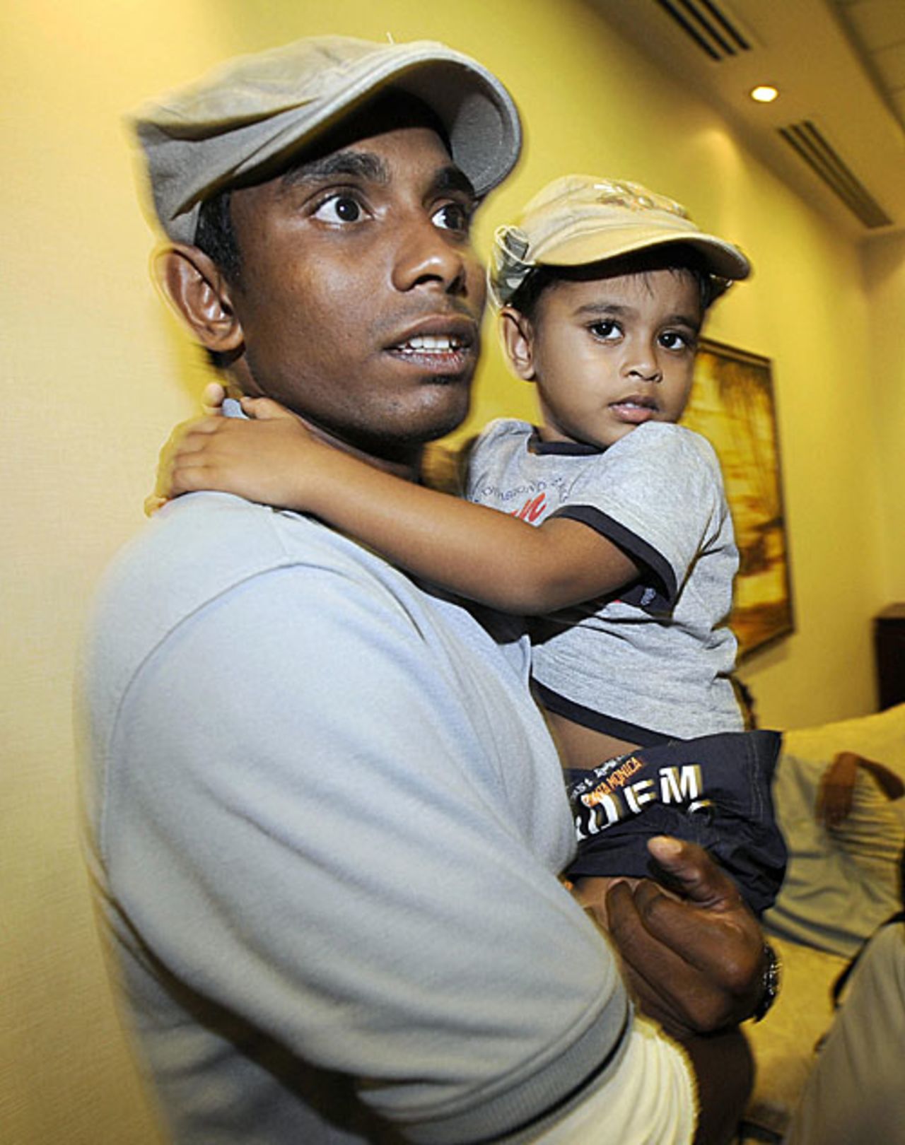 Thilan Thushara holds his son at Colombo airport, Colombo, March 3, 2009