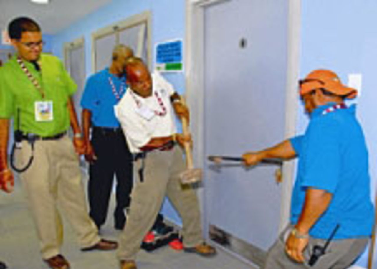 Security and maintenance personnel try to break down the restroom door at the Kensington Oval, Barbados, March 1, 2009