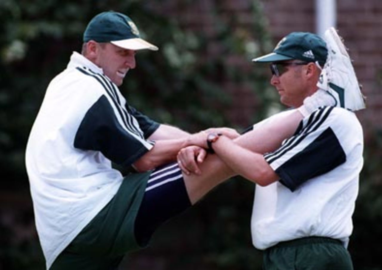 Allan Donald gets his hamstring stretched by team physio, Craig Smith , during the South Africans' nets session at the SCG on New Year's Day, 1998.