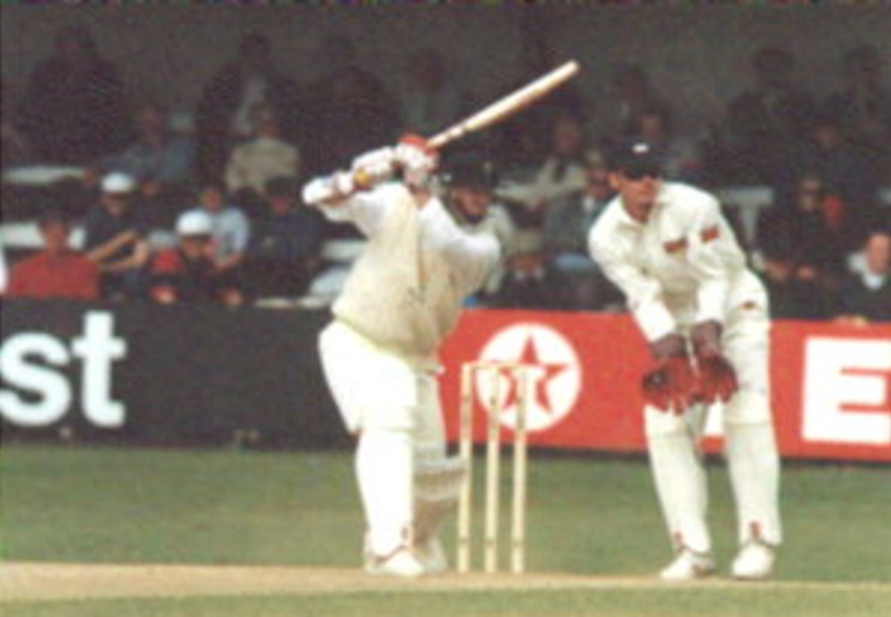 Hugh Morris square drives Yorkshire`s Richard Stemp, watched by wicket-keeper Richard Blakey during their Championship encounter at Cardiff in 1996.