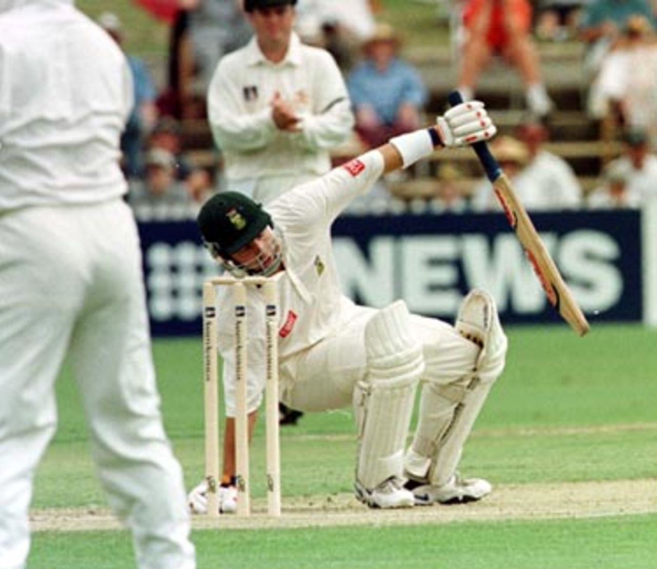 Adam Bacher on the ground as he avoids a bouncer ..Australia v South Africa 3rd Test, Day 1 at the Adelaide Oval, Friday January 30th 1998.