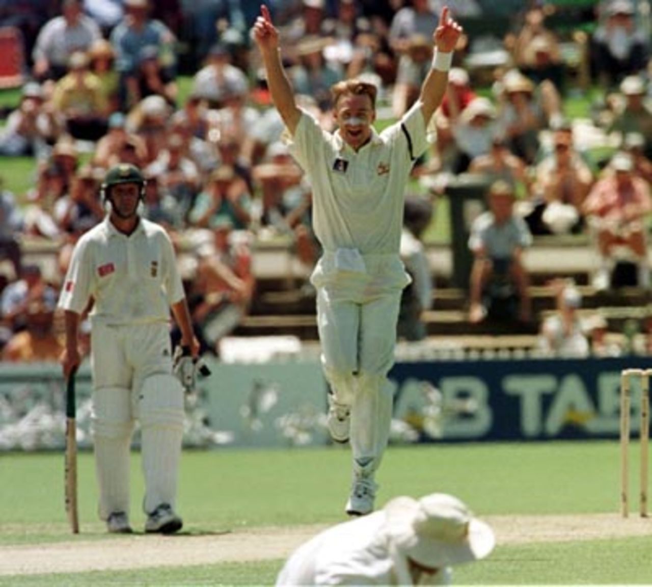 Andy Bichel does the victory salute as Shane Warne catches Adam Bacher for 64..Australia v South Africa 3rd Test, Day 1 at the Adelaide Oval, Friday January 30th 1998.