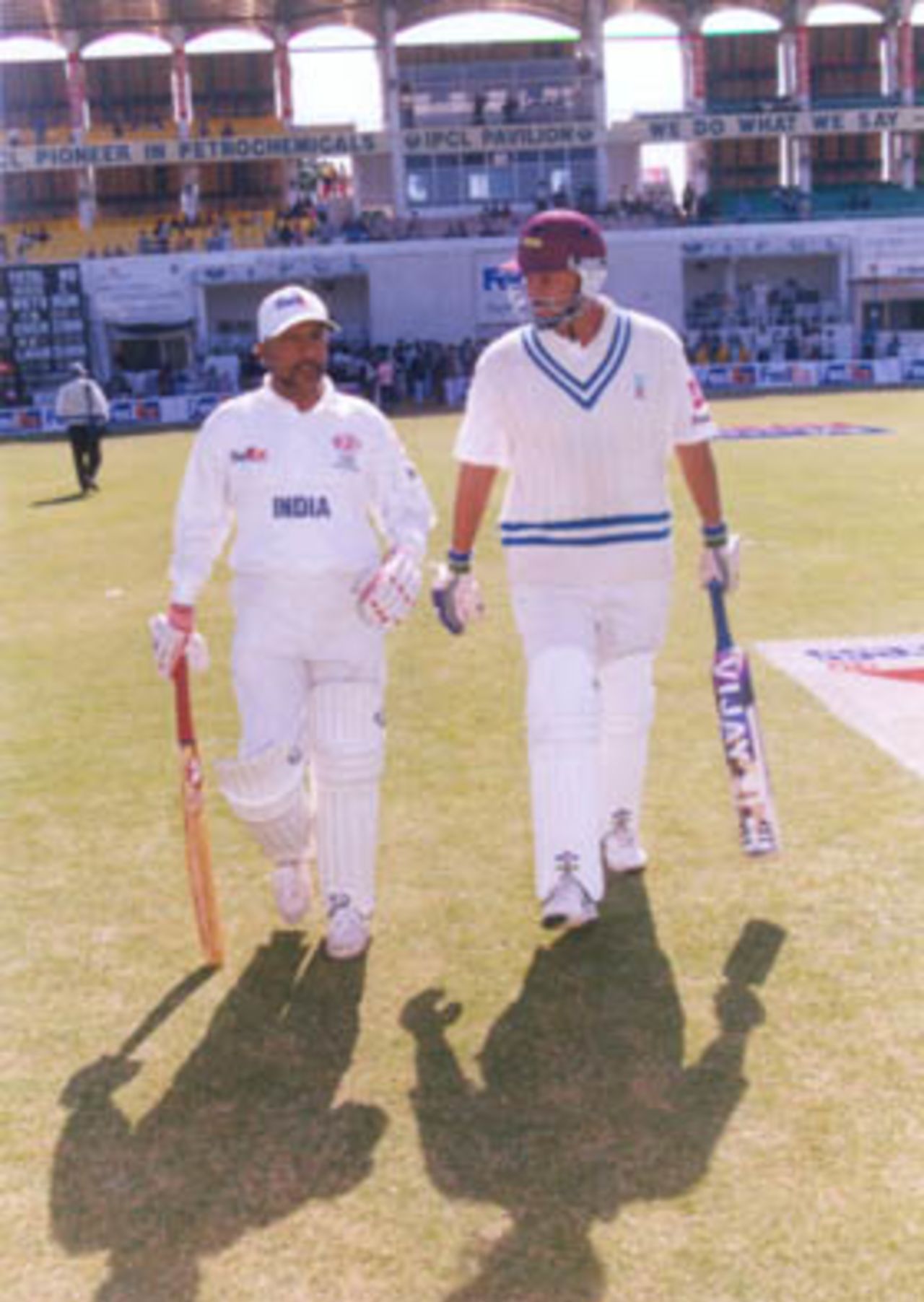FedEx Cup 1999, Second OD: Syed Kirmani and Roger Binny coming onto the field to open the Indian innings