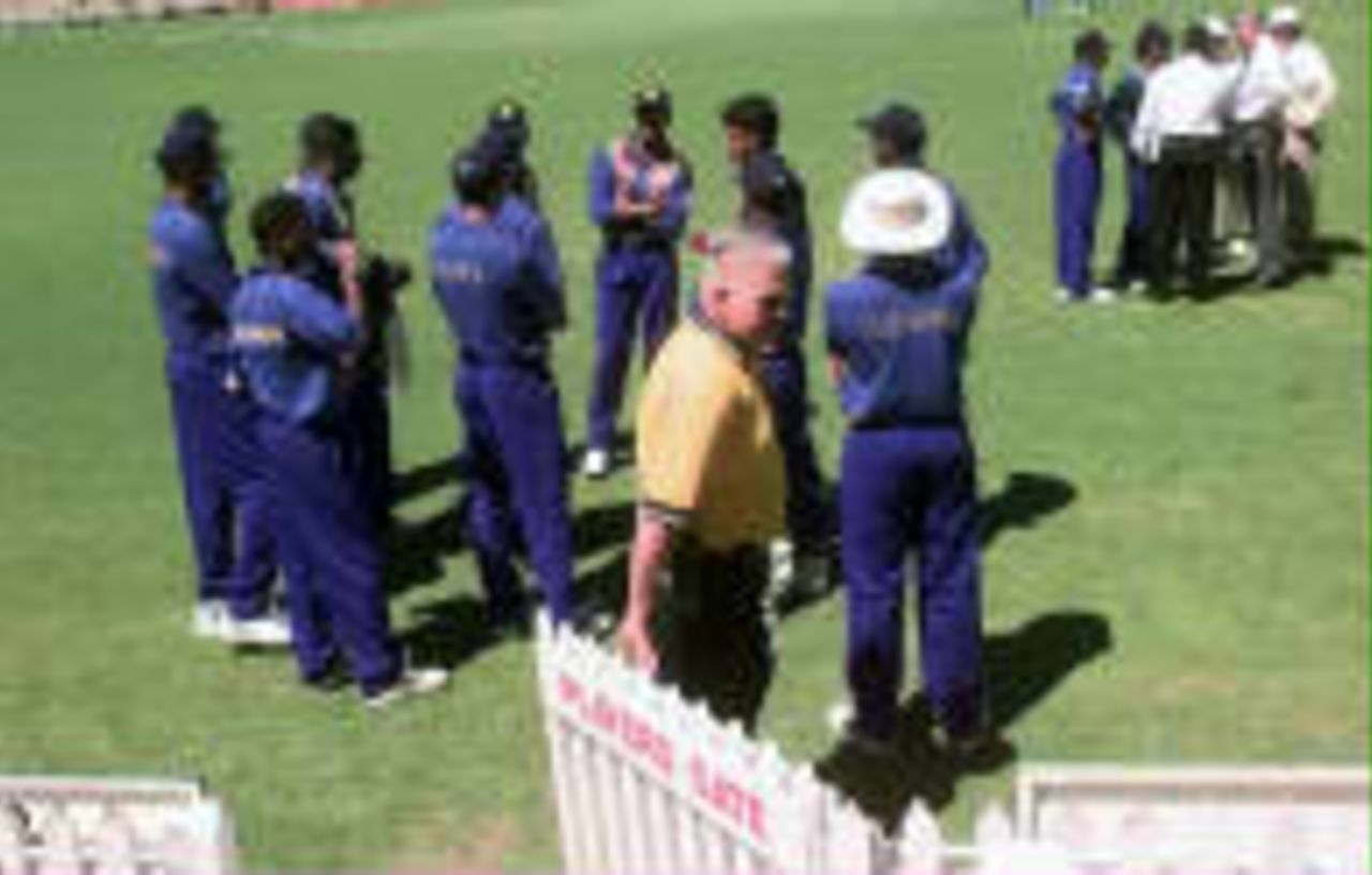 The Sri Lankan team waits as Ranatunga tries to resolve matters after Muralitharan was "called"  for throwing by umpire Ross Emerson   - Carlton & United One-Day Series, 1998-99, 8th Match England v Sri Lanka Adelaide Oval, Adelaide, South Australia (day/night) 23 January 1999