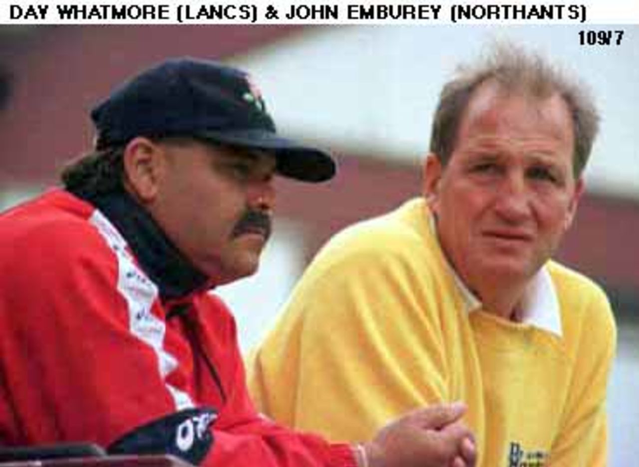 Coaches Day Whatmore of Lancs and John Emburey of Northants look on at the game.