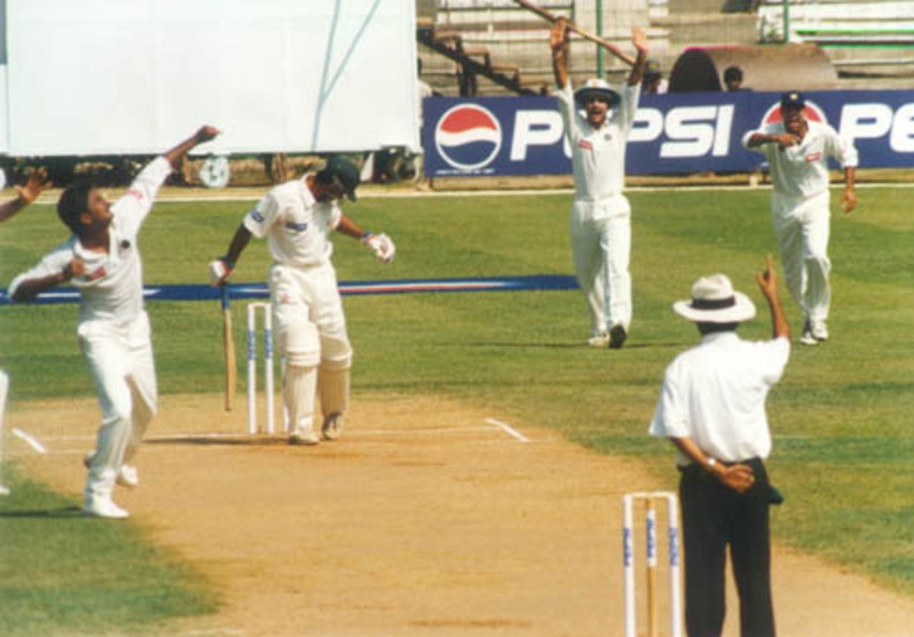 Saeed Anwar is out lbw, shouldering arms. Srinath exults as Ganguly and Laxman in the slips rush forward. India v Pakistan, Test 1, Day 1 at Chennai, 28 January 1999