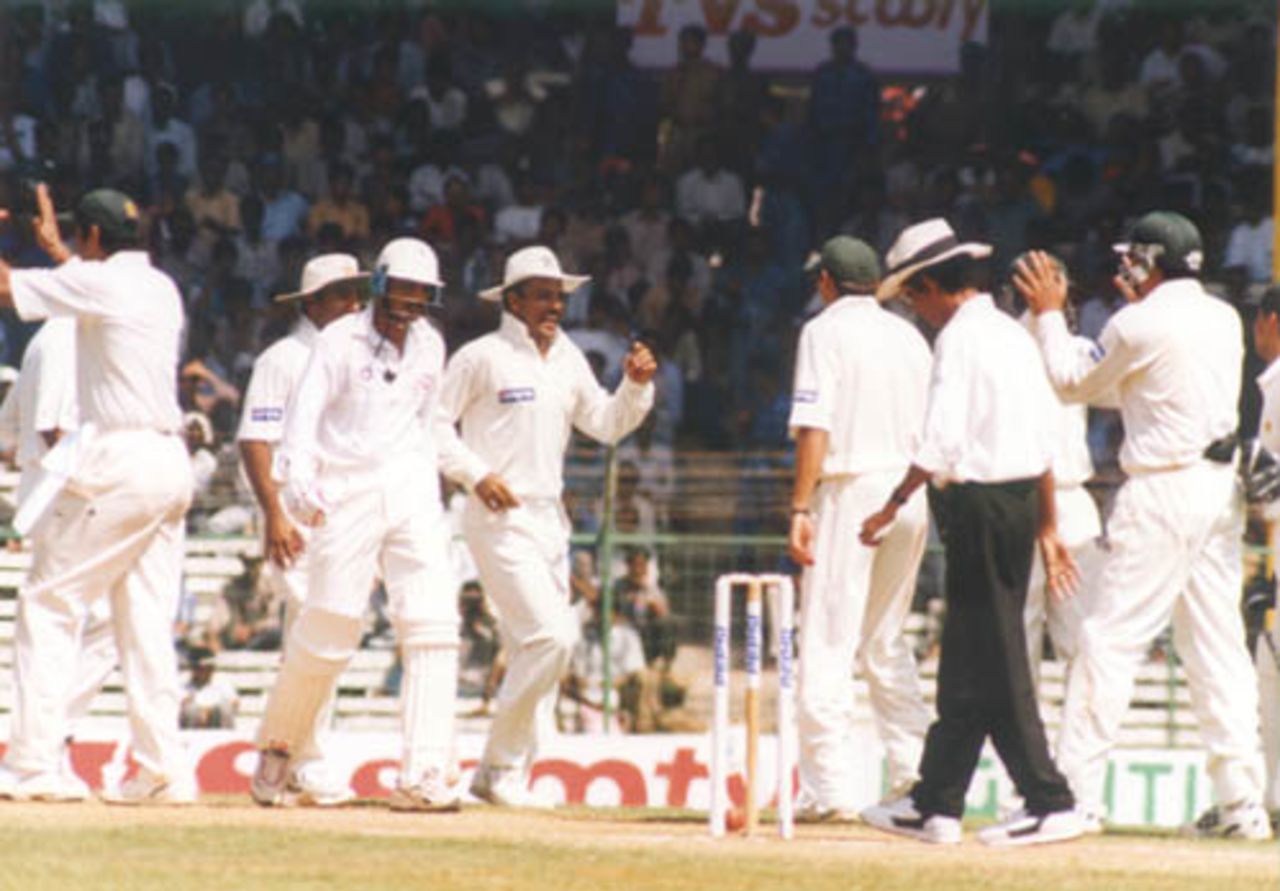 Pakistani fielders celebrate as Azharuddin walks back to the pavilion. India v Pakistan, Test 1, Day 2 at Chennai, 29 January 1999